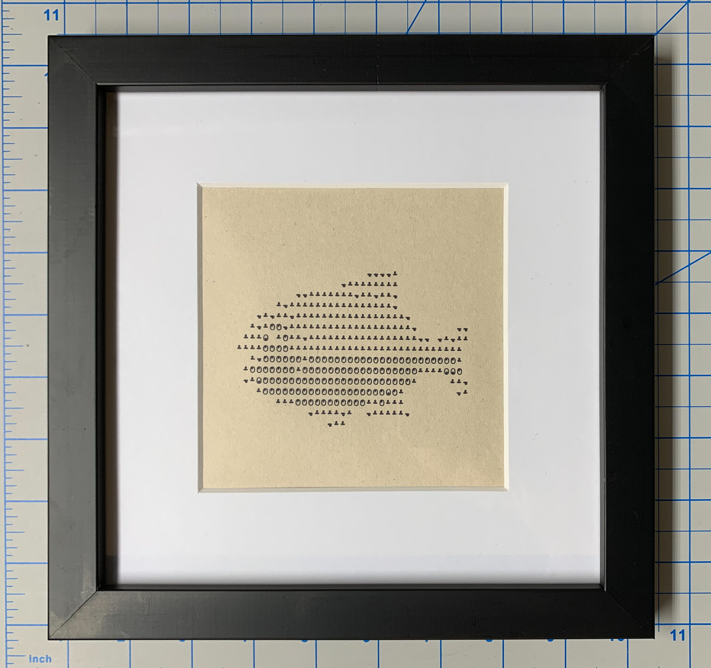 Fish emoji printed in overstrike on Teletype, framed