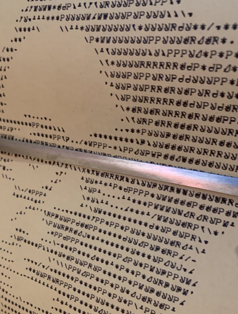 Close-up of overstrike printing showing layered characters